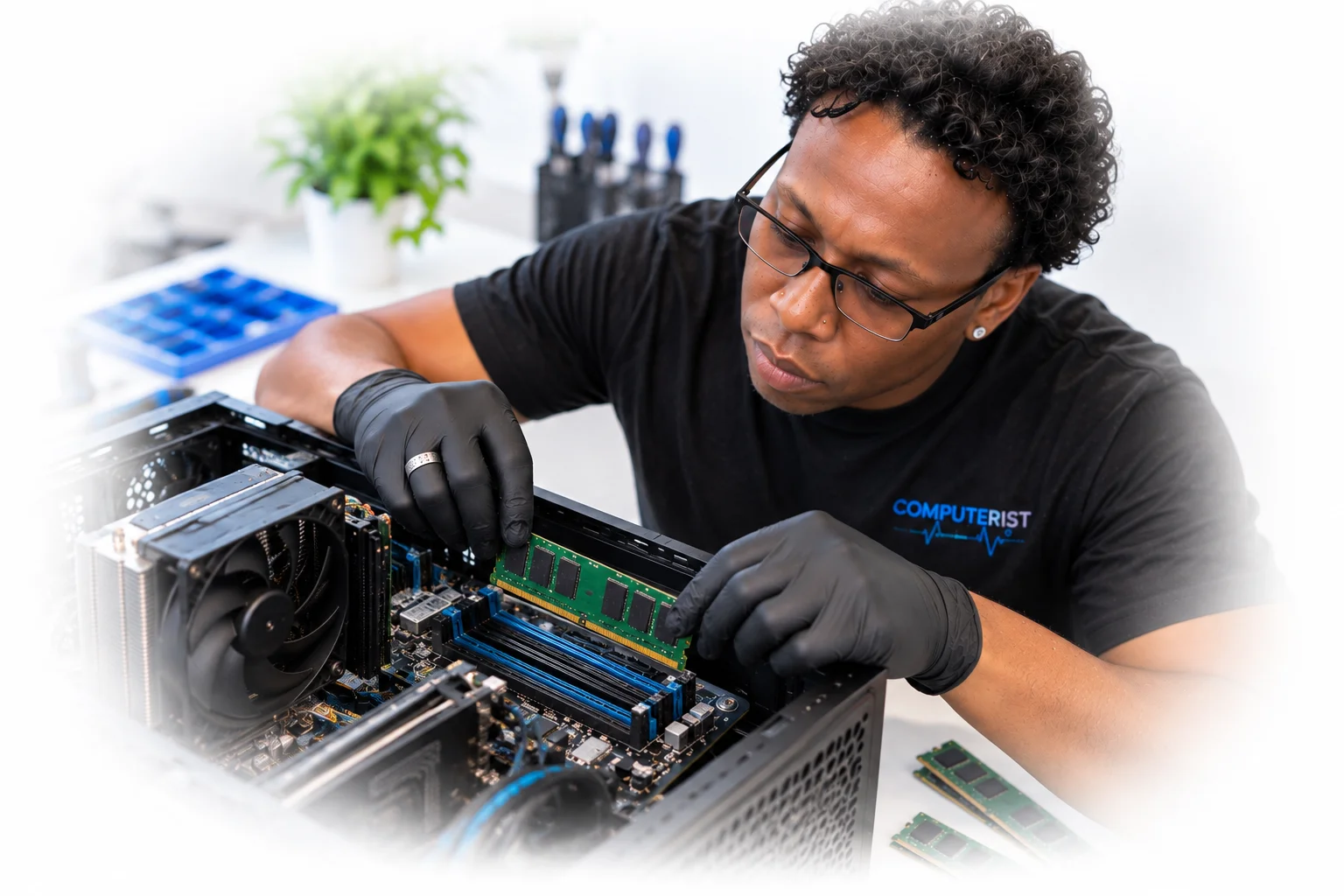 Computer technician installing RAM modules into a desktop motherboard.
