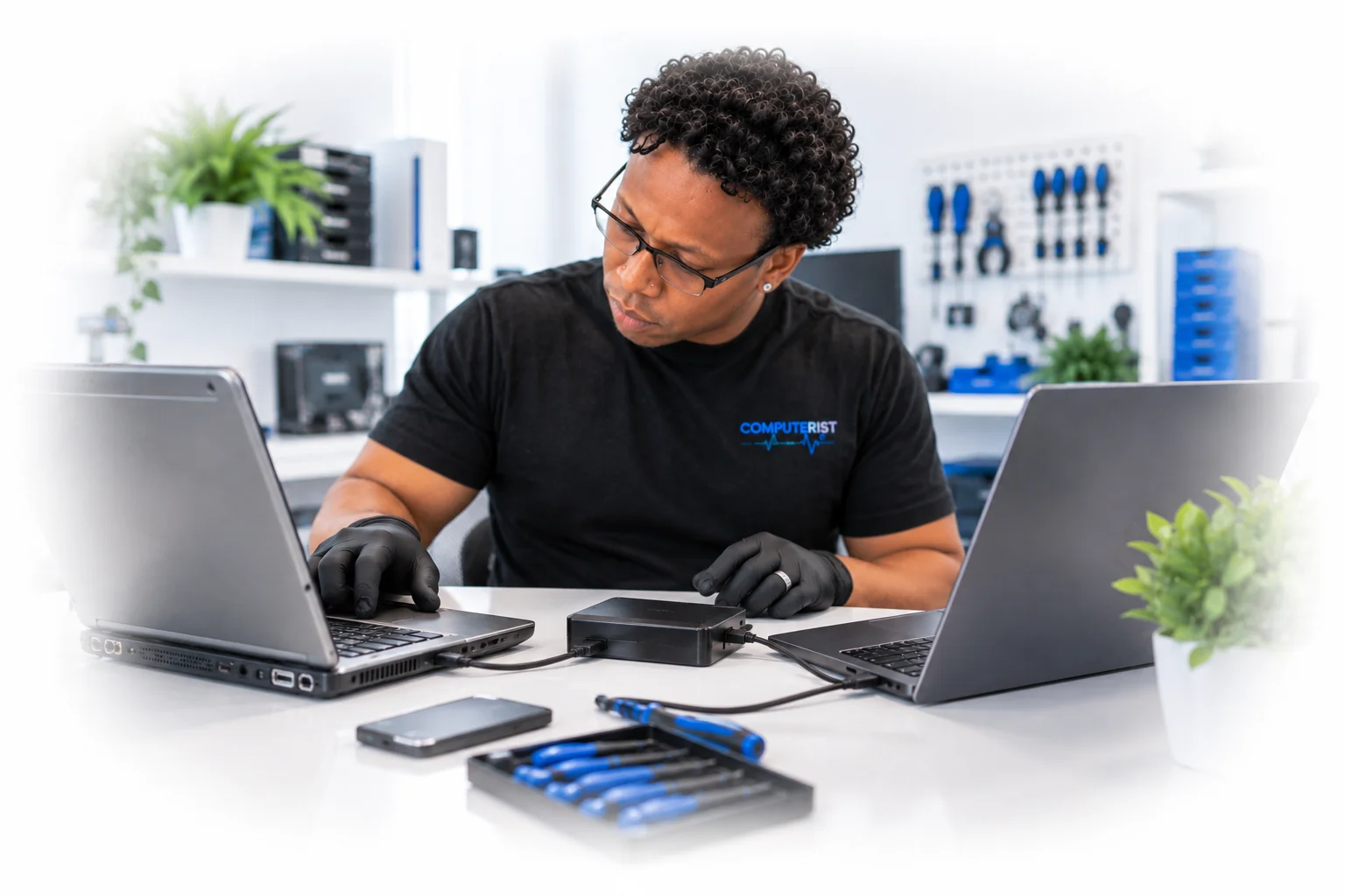 Computer technician transferring customer data while upgrading computer hardware.

