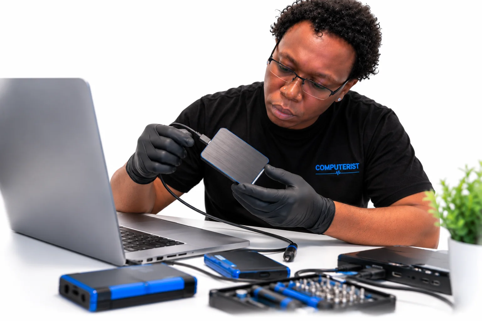 Data Recovery 105 Computerist technician diagnosing an external storage drive connected to a Mac