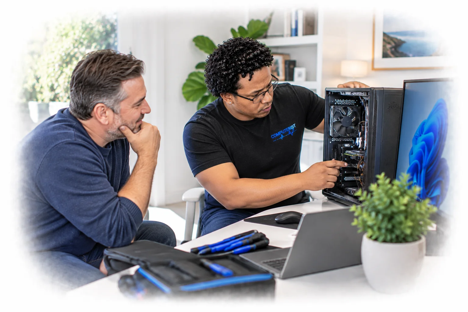Computer technician helping a customer prepare their computer for an upgrade.
